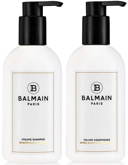 Kaksi valkoista pulloa, joissa on mustat suihkut, merkinnät 'Volume Shampoo' ja 'Volume Conditioner', Balmain Parisilta.