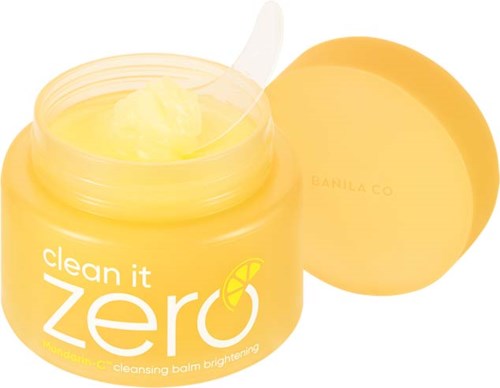 Ein gelber Behälter mit Hautpflegeprodukt, beschriftet "clean it zero" mit Zitronensymbol, Inhalt sichtbar.