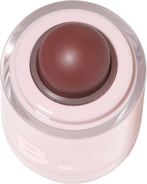 A brown round makeup product inside a clear container, with a pink base.