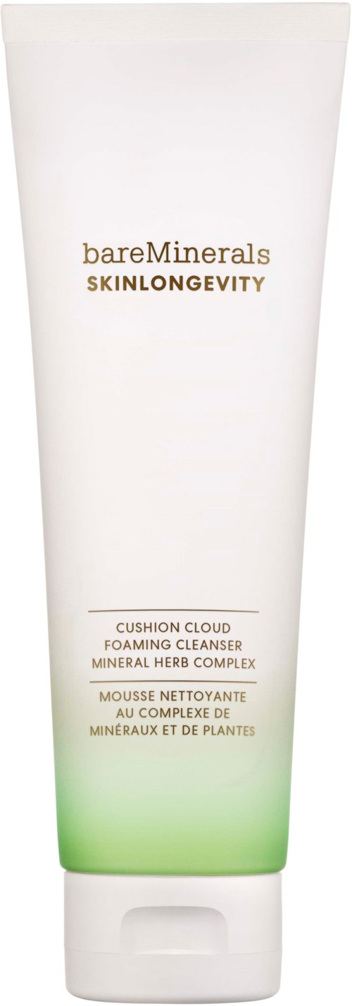 A white tube with green at the bottom, labeled 'bareMinerals SKINLONGEVITY' and 'Cushion Cloud Foaming Cleanser.'