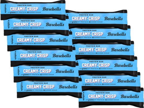 Multiple Barebells Creamy Crisp protein bars stacked, blue and black packaging, text indicates they are protein-rich and low sugar.