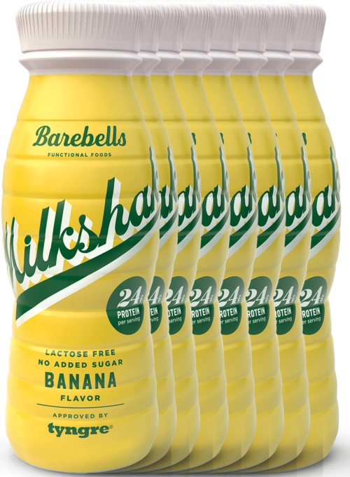 Six bottles of banana-flavored drink with yellow labels, indicating lactose-free and high protein content.