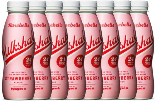 Seven pink bottles of strawberry-flavored milk with white caps, lined up, showing brand and label details.