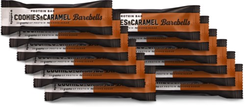 Multiple protein bars labeled Cookies & Caramel Barebells are stacked, mainly black and orange packaging.