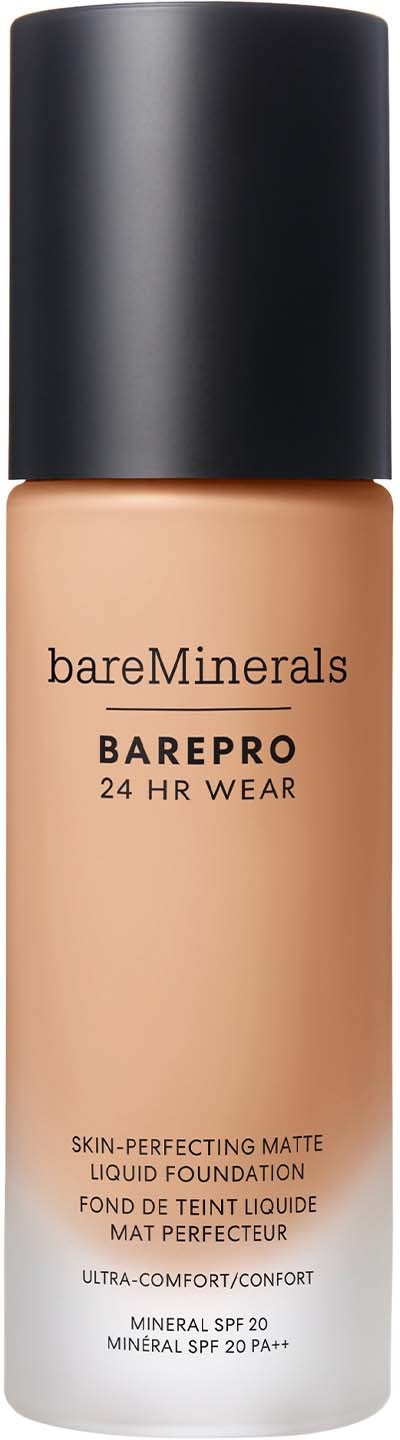 A foundation bottle with a black cap and beige liquid inside. The label shows brand, type, and SPF details.
