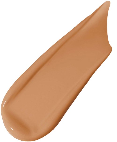 A swatch of beige liquid foundation with a smooth, creamy texture next to a curved fabric edge.