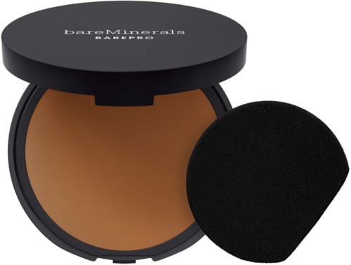 A compact face powder with a sponge applicator in a round black container.