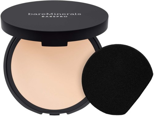 A compact makeup powder with a black lid and a round sponge applicator.