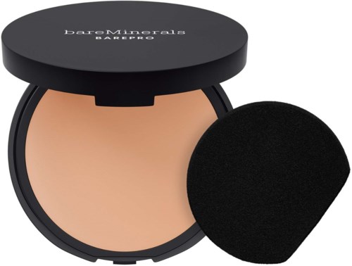 A compact of BareMinerals powder foundation with a black sponge applicator.