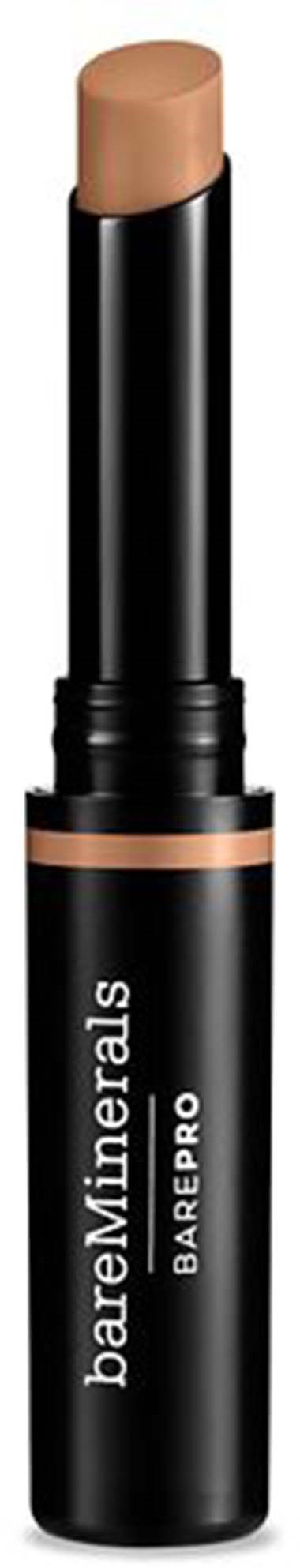 En beige makeup-sticka i ett svart rör märkt BareMinerals BarePRO. Hatten är borttagen, vilket visar produkten.