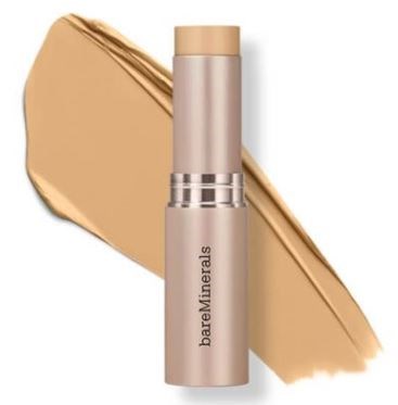 En beige stift med lock, märkt 'bareMinerals', med ett swatch av matchande beige smink bakom.