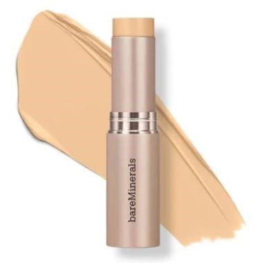 En beige tube av BareMinerals sminkprodukt med ett lager av foundation bakom.