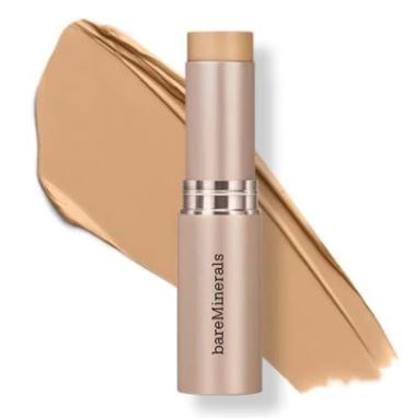 En beige BareMinerals foundationstav med en spridning av produkten bakom den.