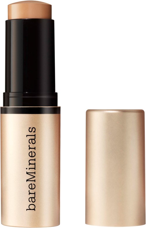 En beige highlighter eller concealer-sticka med svart lock från BareMinerals. Locket är borttaget, och produkten är synlig.