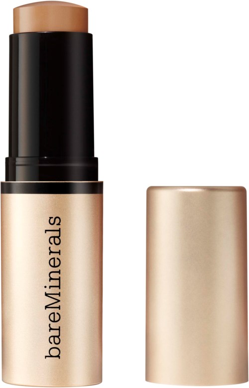 En beige stift med svart lock och guldbehållare som heter bareMinerals.