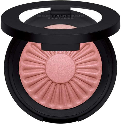 A round blush makeup compact with a mirror, containing a pink, sunburst-patterned powder.
