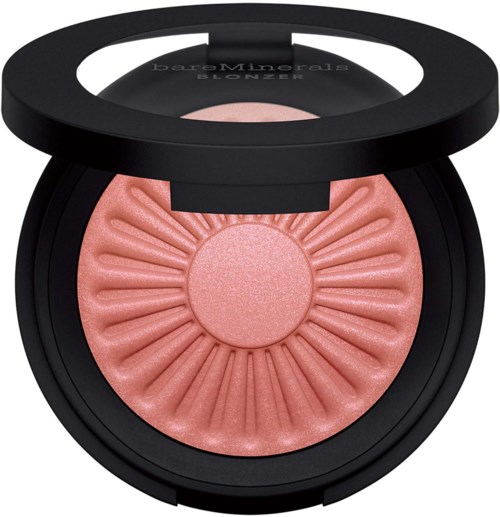 A pink, shimmery blush in a black compact with a clear lid and embossed sunburst pattern.