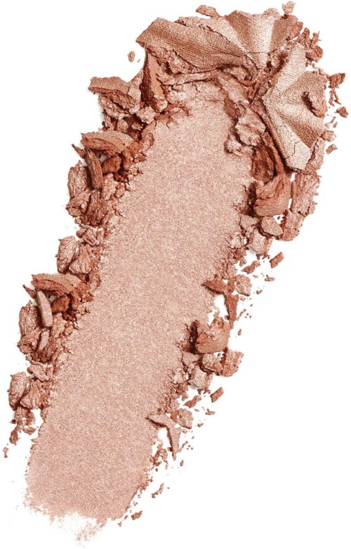 A crushed beige powder with rough edges, likely makeup or cosmetic powder. It is spread out unevenly.