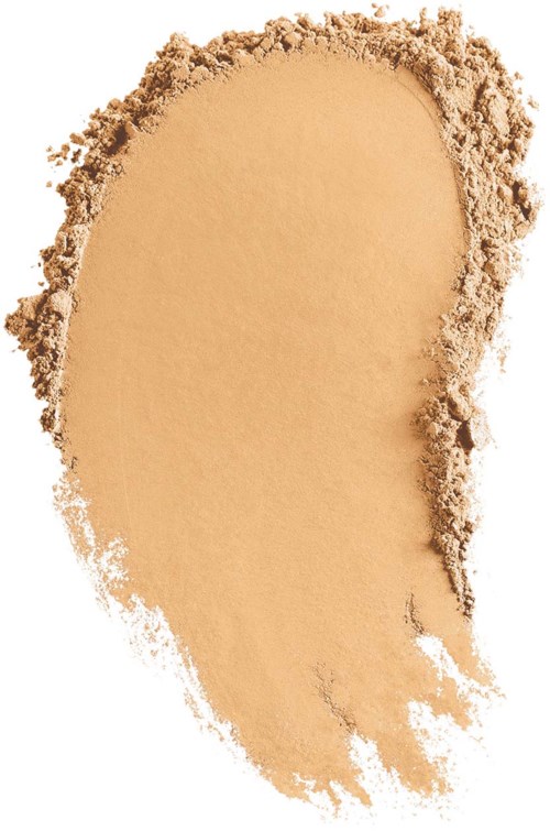 Ljusbeige pulver med ojämna kanter, spridd på en vit bakgrund.