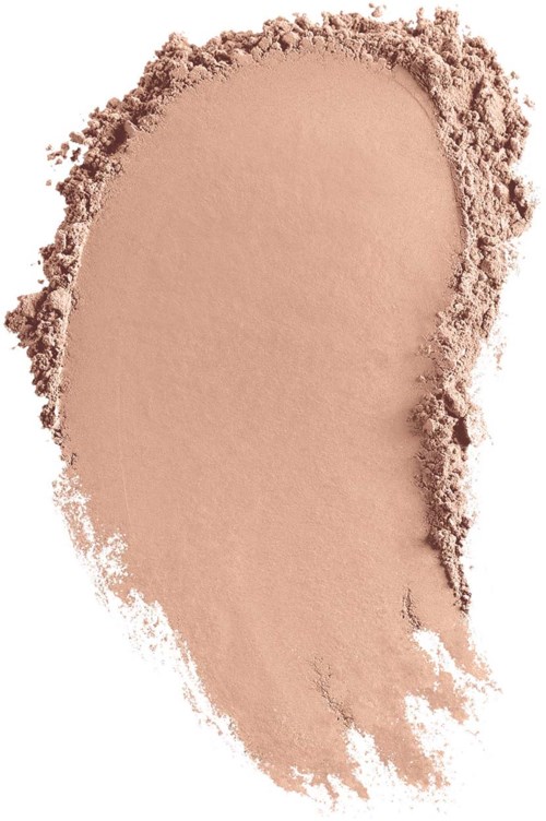 A beige, powdery makeup or face powder spread out in a rough teardrop shape.