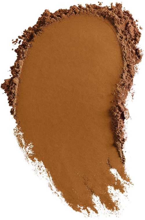 The image shows a patch of brown powder, possibly makeup or pigment, with rough edges on a white background.