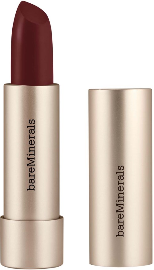 A dark red lipstick in a gold tube with brand name BareMinerals. The cap is removed, revealing the lipstick.