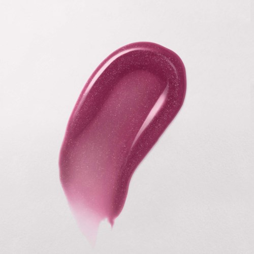 A pink, sparkly, curved makeup brush or applicator against a light background.