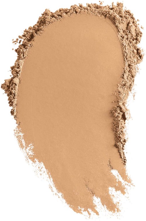 Ein beige Pulver ungleichmäßig verteilt mit rauer Kante und einigen lockeren Partikeln.