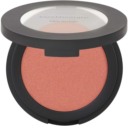 A round makeup compact with coral blush inside and a clear lid showing the brand BareMinerals.
