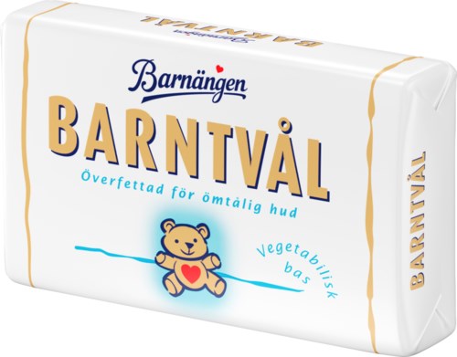 A soap bar with text in Swedish, a bear cartoon, and small heart symbol. It mentions vegetable-based and gentle for skin.