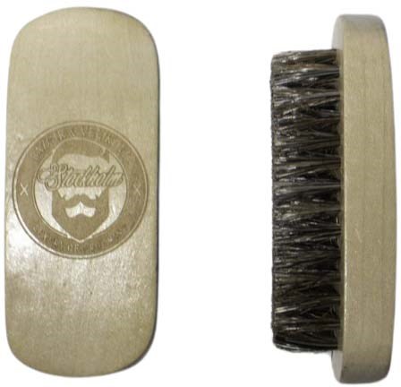 A beige shoehorn with a logo featuring a bearded man and the word 'Stadthof'. It has a black brush on the back.