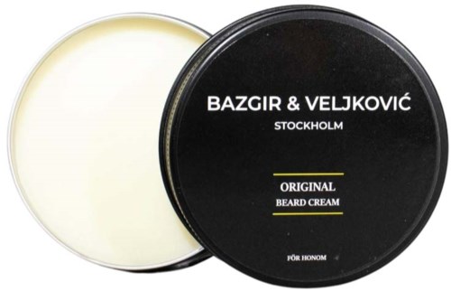 A black round container of beard cream with white and yellow text, and a white lid showing the cream.
