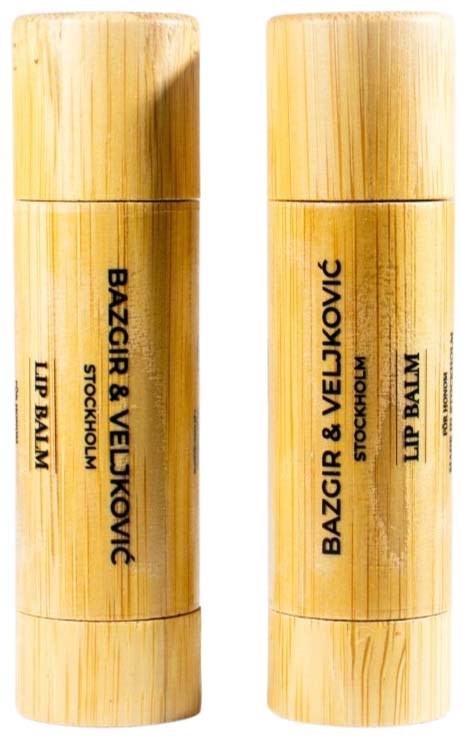 Two lipstick containers with bamboo design and black text. They are side by side, similar in shape and size.