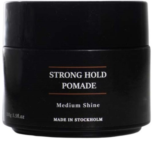 A black container labeled 'Strong Hold Pomade' for medium shine, made in Stockholm, contains 100g of hair styling product.