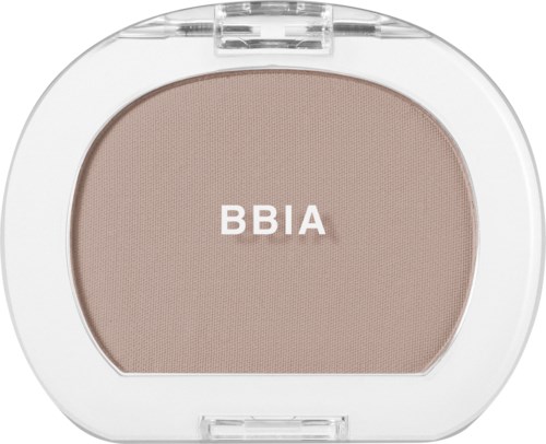 A compact powder container with a beige powder and the word BBIA on it.