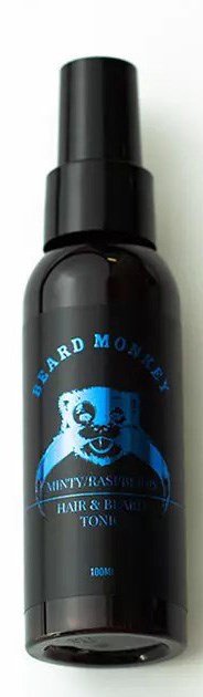 Black bottle with a blue label featuring a panda face, containing beard growth oil for men.