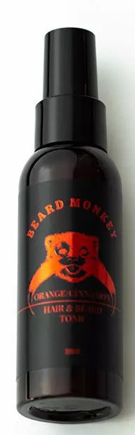 A black spray bottle with a red and orange bear logo and text, labeled 'Beard Money.'