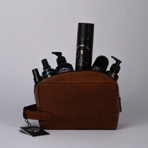 A brown bag filled with hair care products and sprays. The bag has a tag attached to it.