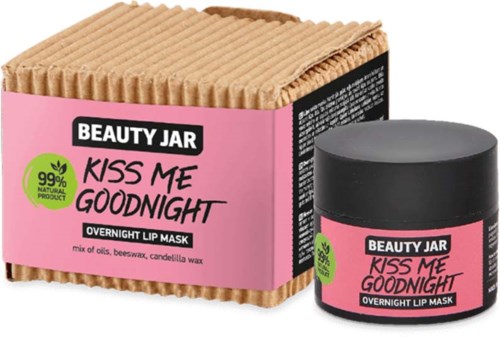 Ein pinker Karton und ein kleiner Behälter mit Nachthautmaske, etiketti "Kiss Me Goodnight," mit natürlichen Inhaltsstoffen und Wachs.