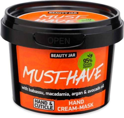 Eine schwarze Kunststoffdose mit dem Aufdruck 'Must-Have' Hand- und Nagelhautcreme-Maske mit natürlichen Inhaltsstoffen und schwarzem Deckel.