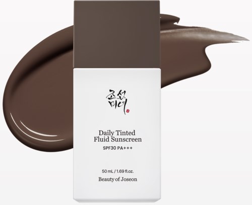 A white bottle of daily tinted fluid sunscreen with a grey cap, surrounded by brown sunscreen spread.