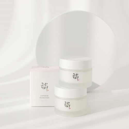 Three white jars with black and red Korean text, set against a round mirror and soft white background.