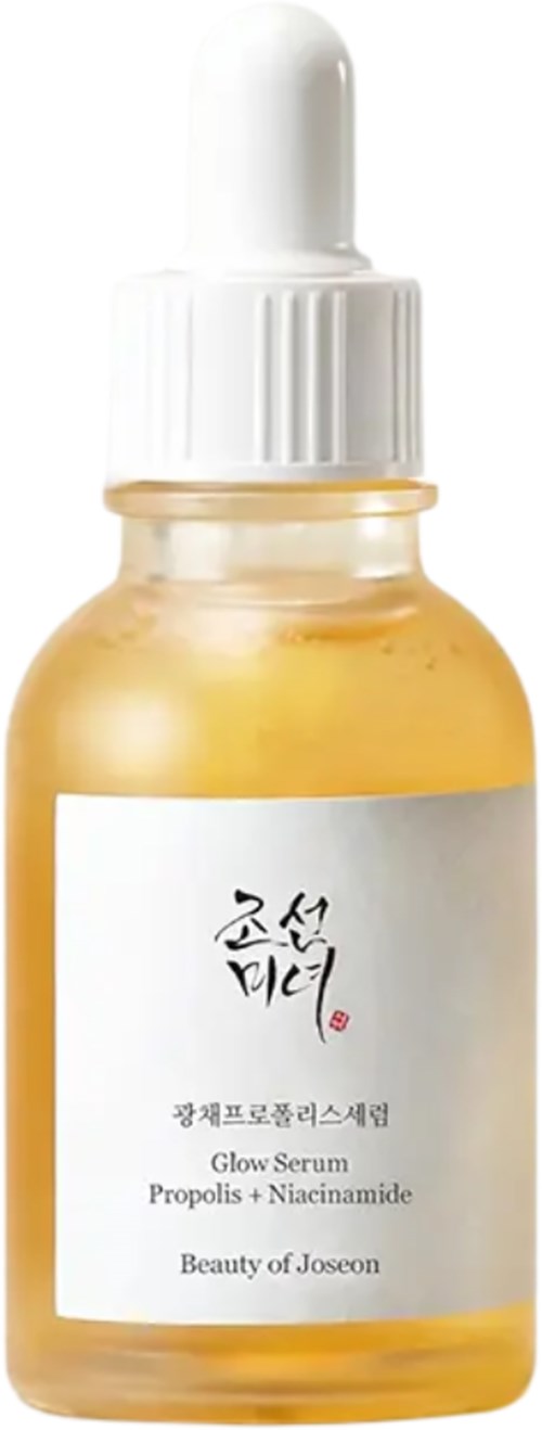 En liten guldfärgad flaska med vit pipettlock och en etikett med koreansk text, skönhetsprodukten och ingredienser.