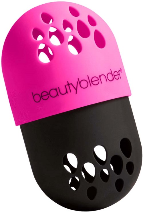 A two-tone plastic makeup sponge with holes, labeled 'beautyblender', used for blending makeup.
