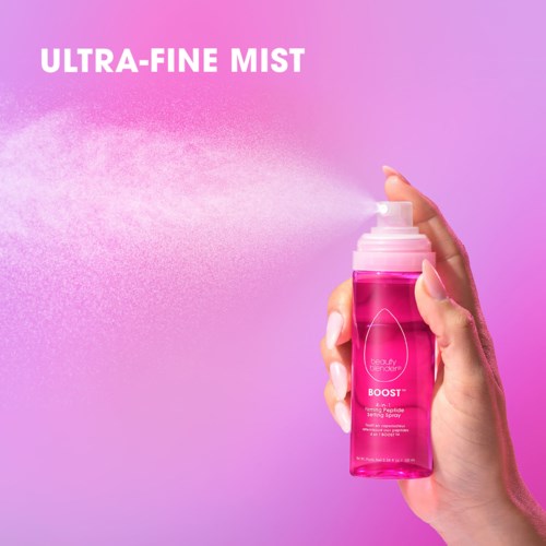 A hand sprays pink mist from a bottle on a pink and purple background. The text says Ultra-Fine Mist.
