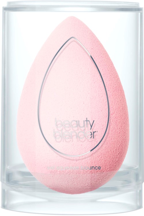 A pink beauty blender sponge inside a clear glass container with a label and outline design.