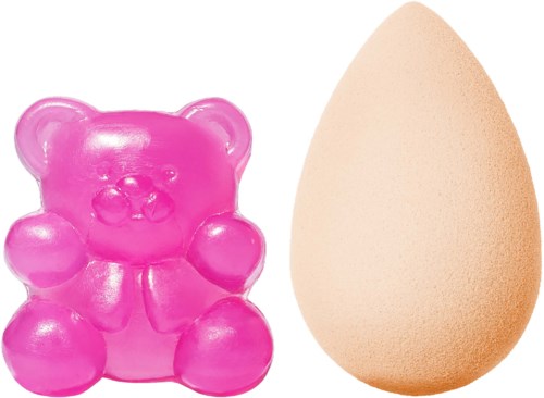 A pink bear-shaped soap and a light brown egg sponge side by side.