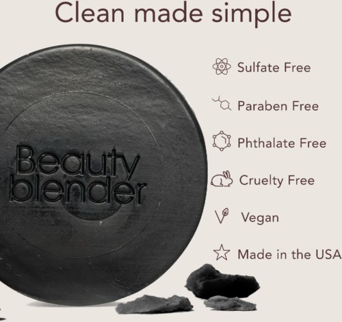 A black round beauty blender with simple text indicating it is free of harmful chemicals and cruelty.
