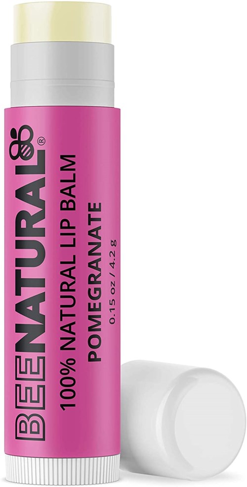 Pink tube of natural lip balm labeled with ingredients and brand name, with white cap beside it.