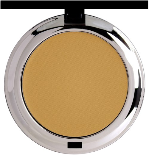 En liten förpackning med en gul makeupprodukt inuti, omgiven av ett glänsande silverfall.